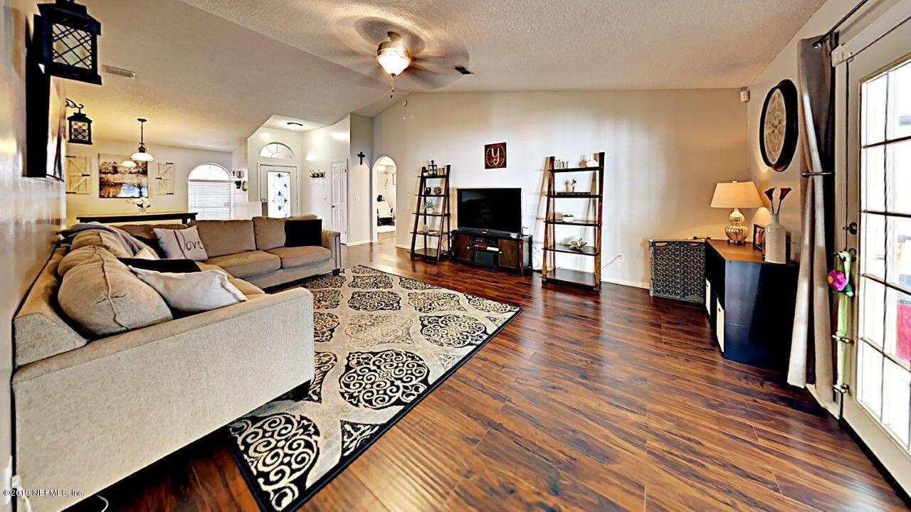 12830 Moose Road Jacksonville, FL 32226 - Photo 9 of 31 a living room with furniture and a flat screen tv