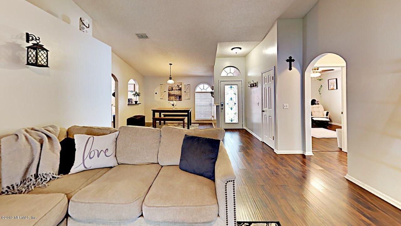 12830 Moose Road Jacksonville, FL 32226 - Photo 10 of 31 a living room with furniture and a wooden floor