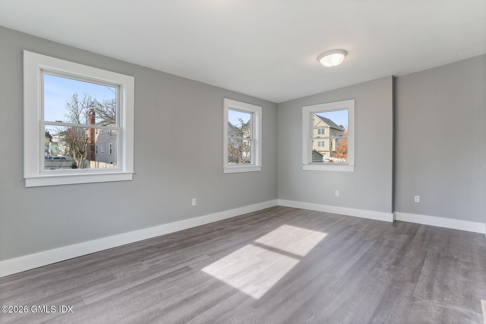 35 Euclid Avenue, Unit B Stamford, CT 06902 - Photo 17 of 27 a view of empty room with window and wooden floor