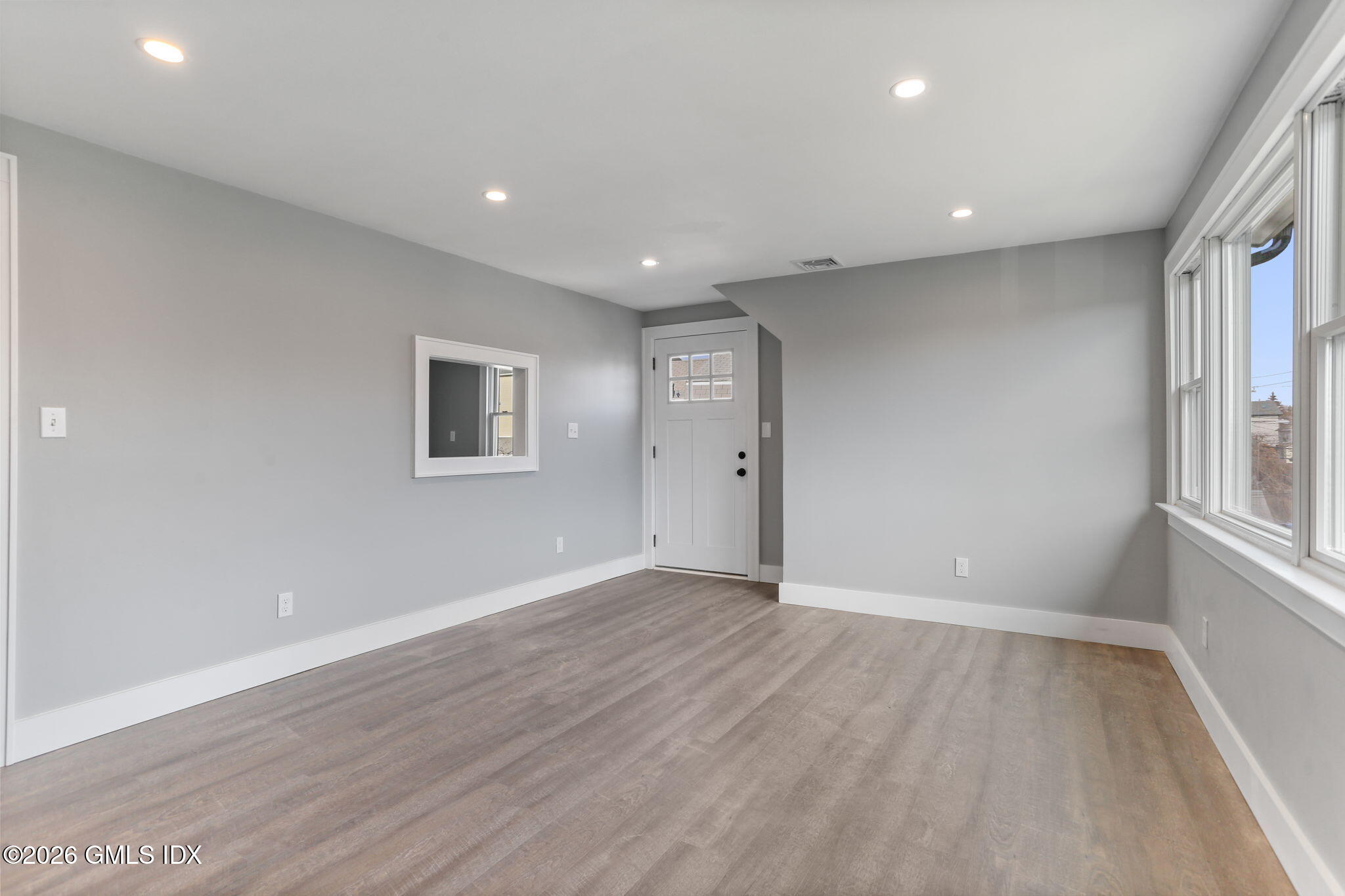 35 Euclid Avenue, Unit B Stamford, CT 06902 - Photo 5 of 27 a view of an empty room with wooden floor and a window