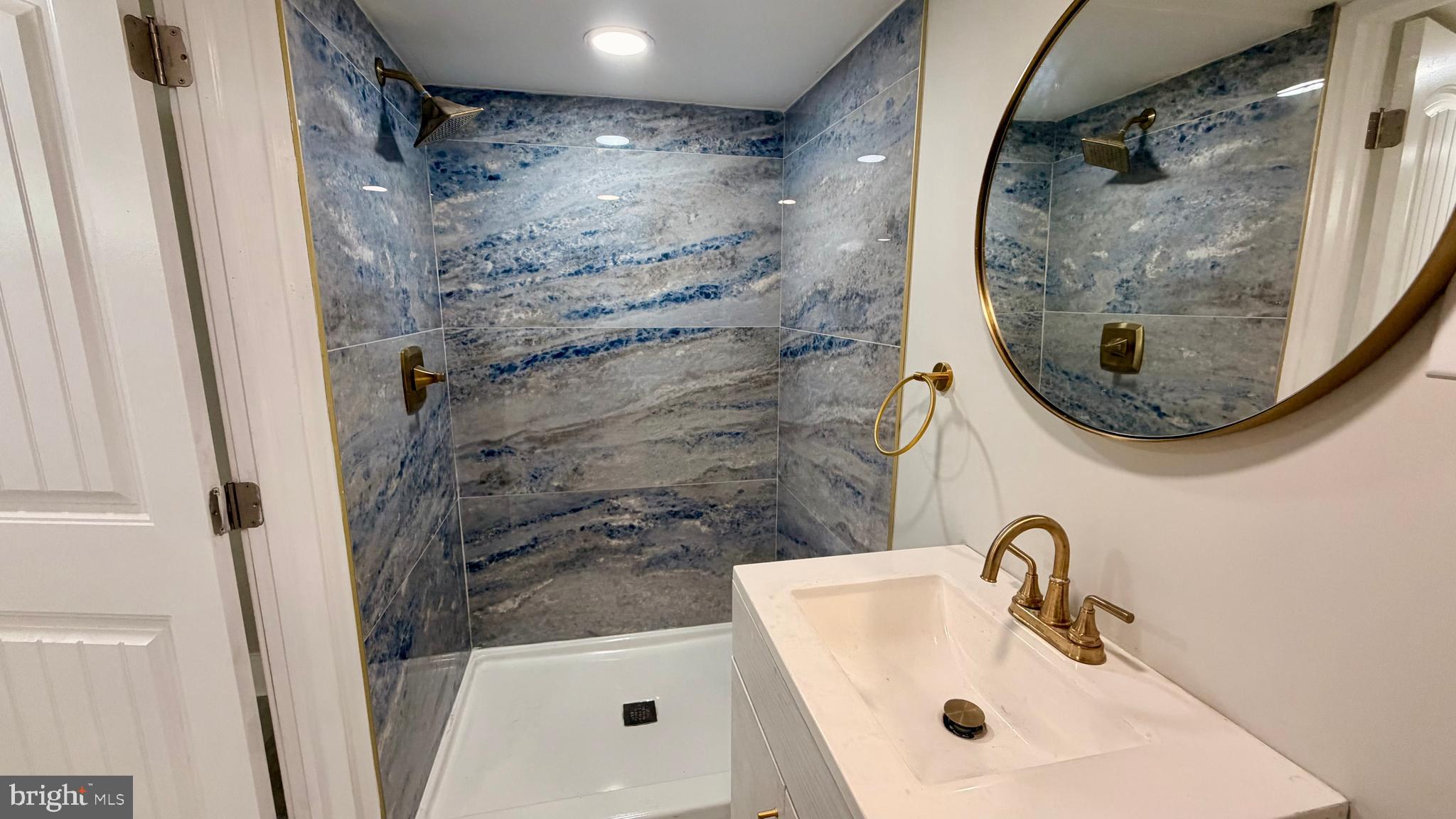 7219 Saul Street Philadelphia, PA 19149 - Photo 21 of 24 a bathroom with a sink and a mirror