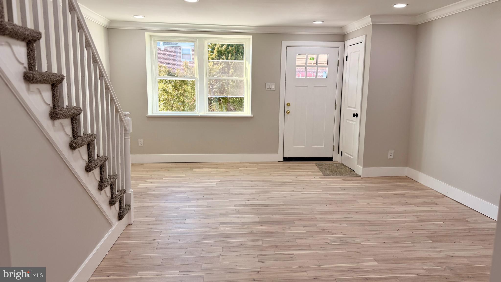 7219 Saul Street Philadelphia, PA 19149 - Photo 3 of 24 a view of an empty room with wooden floor and a window