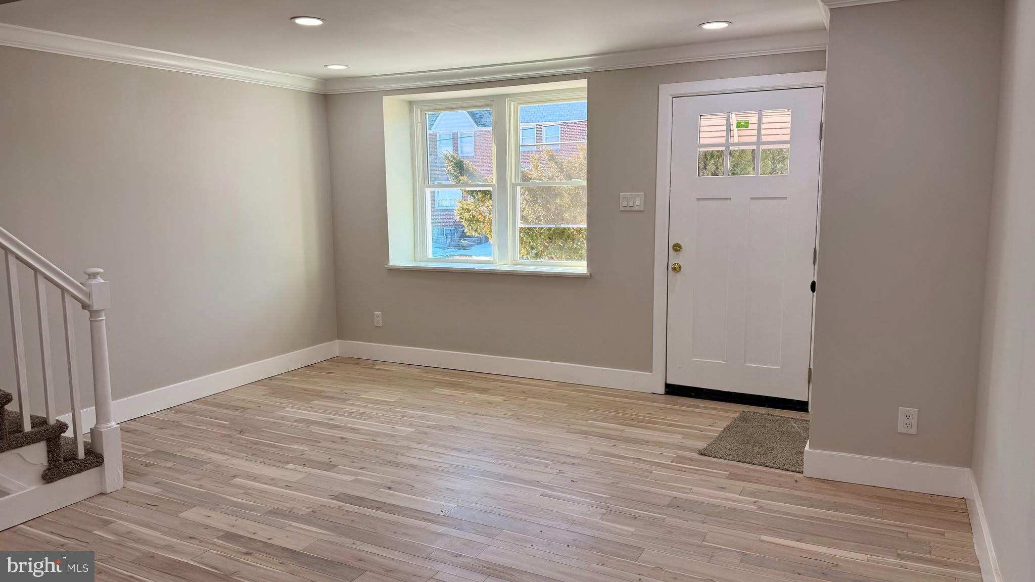 7219 Saul Street Philadelphia, PA 19149 - Photo 4 of 24 a view of an empty room with wooden floor and a window