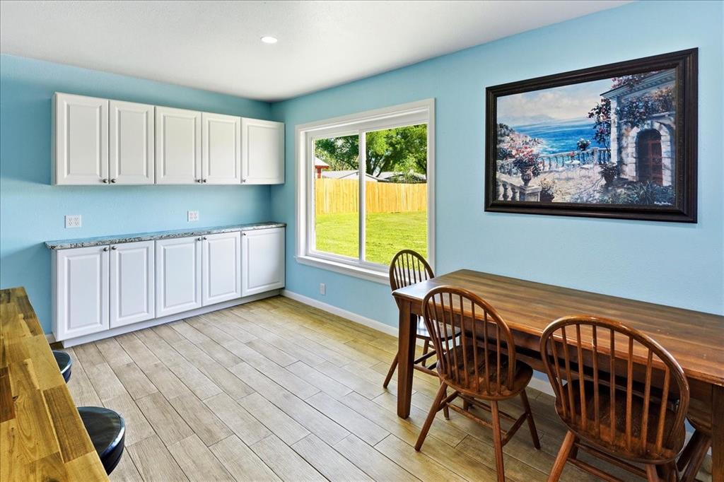 12657 Alma Street Tyler, TX 75704 - Photo 13 of 36 a view of a dining room with furniture and wooden floor
