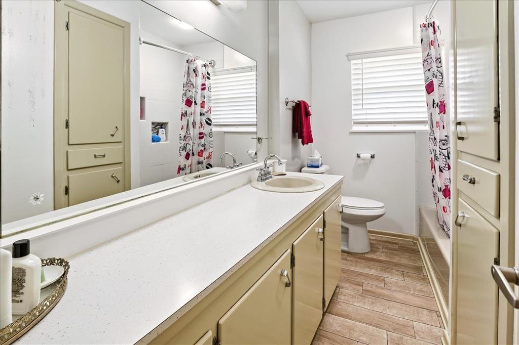 12657 Alma Street Tyler, TX 75704 - Photo 18 of 36 a bathroom with a sink a toilet and shower curtain