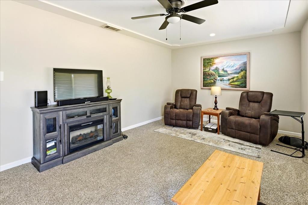 12657 Alma Street Tyler, TX 75704 - Photo 2 of 36 a living room with furniture and a flat screen tv