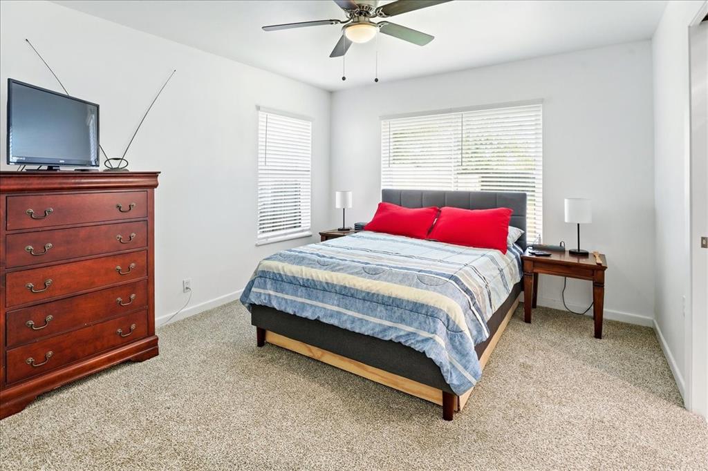 12657 Alma Street Tyler, TX 75704 - Photo 23 of 36 a bedroom with a bed and a flat screen tv