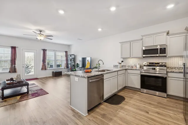 a kitchen with sink a stove and cabinets