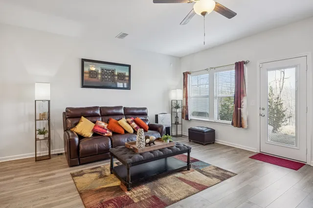 a living room with furniture rug and window