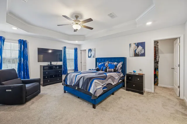 a bedroom with two bed and a lamp on dresser