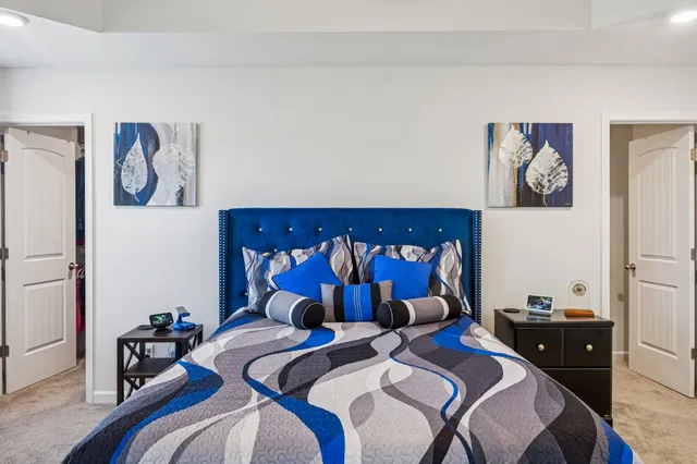 a bedroom with a bed and a chandelier