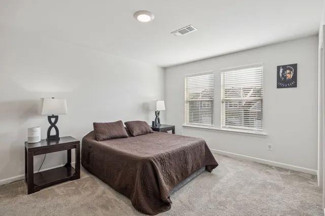 a bed room with a bed and a chair