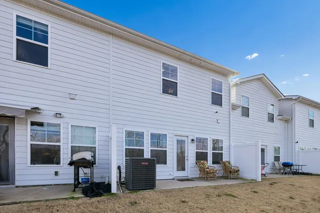 a view of a house with a patio and a car parked in front of house