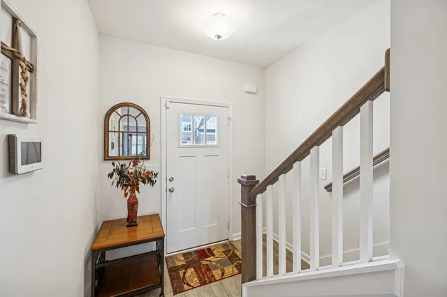 a view of staircase with wooden floor and a chandelier