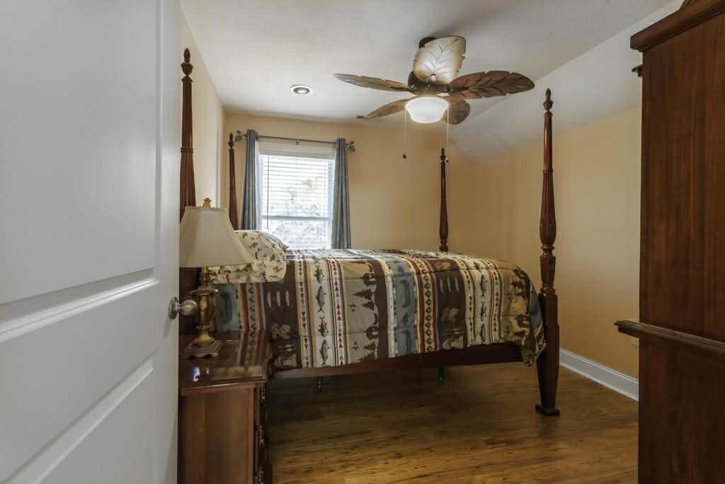 637 River Road Clifton, TN 38425 - Photo 14 of 19 a bedroom with a bed and a chandelier