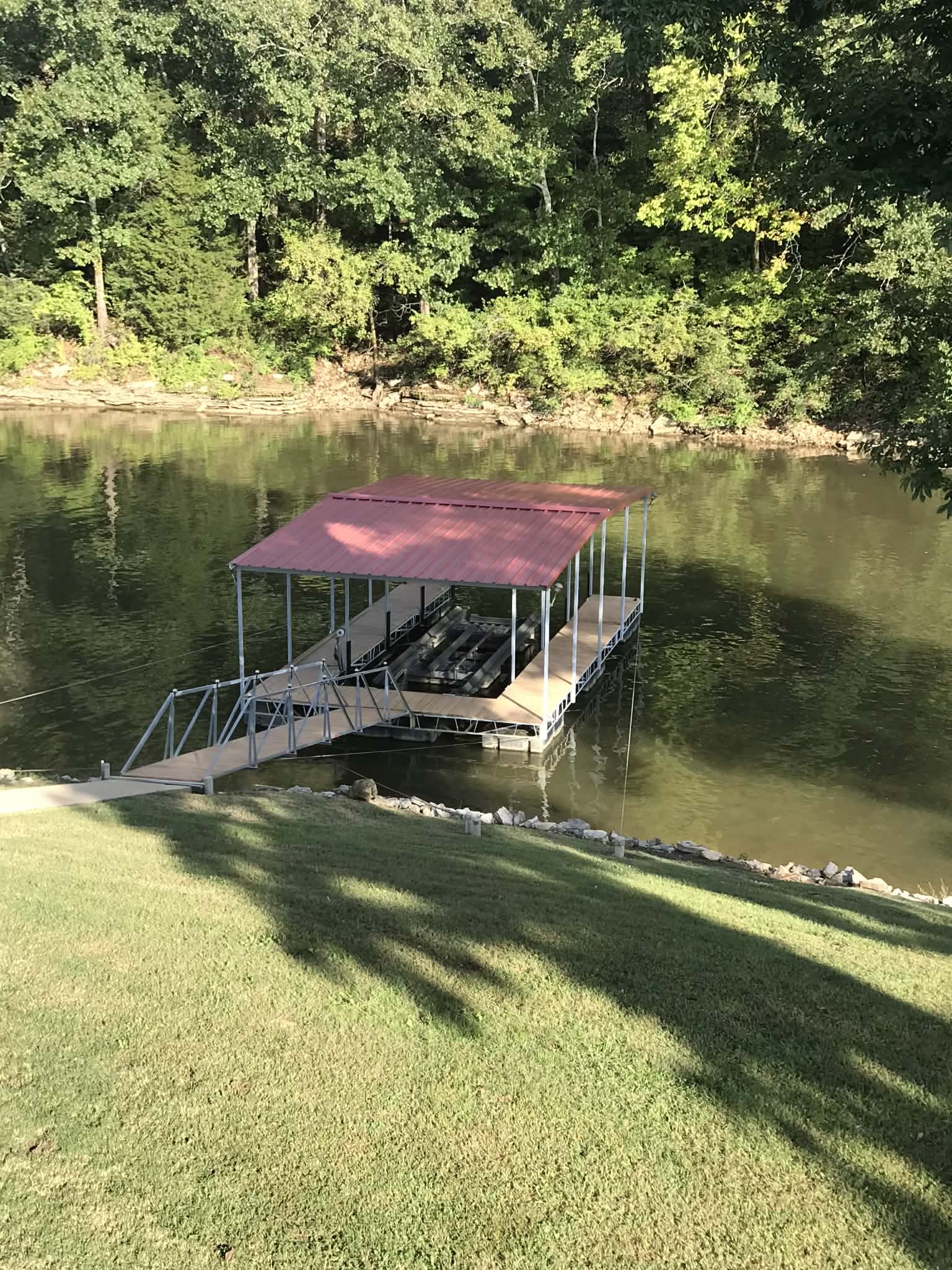 637 River Road Clifton, TN 38425 - Photo 16 of 19 a view of a lake with a house in the background