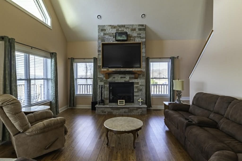 637 River Road Clifton, TN 38425 - Photo 8 of 19 a living room with furniture a flat screen tv and a fireplace