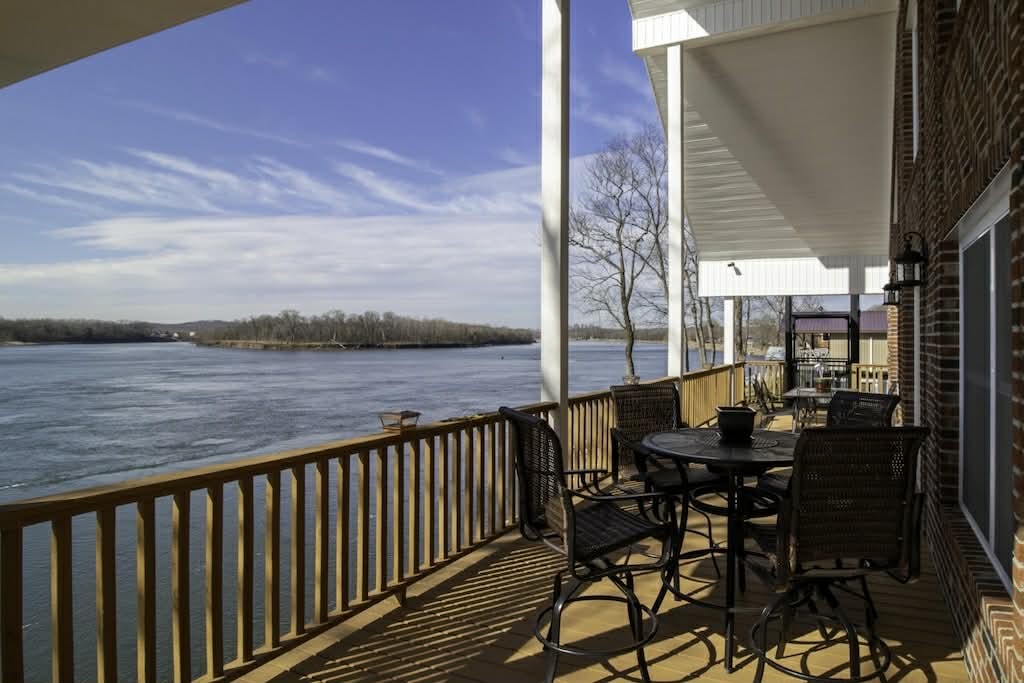 637 River Road Clifton, TN 38425 - Photo 9 of 19 a view of a balcony with chairs and wooden fence