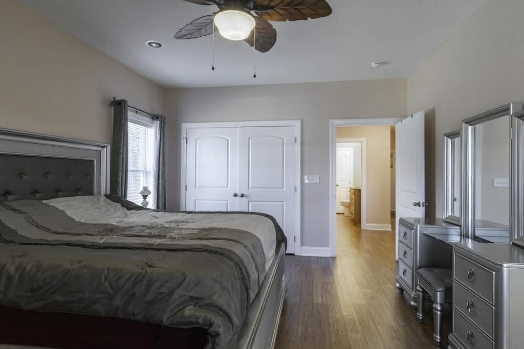 637 River Road Clifton, TN 38425 - Photo 10 of 19 a bedroom with a bed and wooden floor