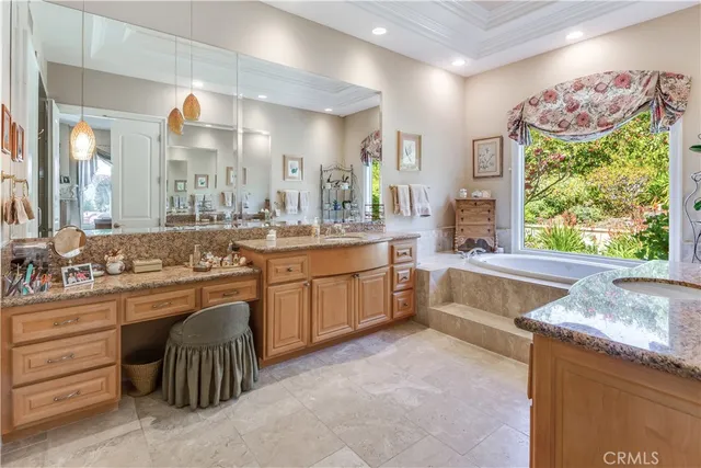a large bathroom with a large tub and sink