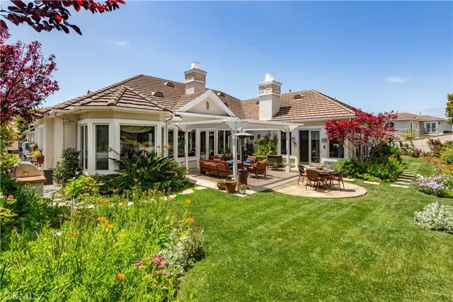 a patio with a table and chairs under an umbrella