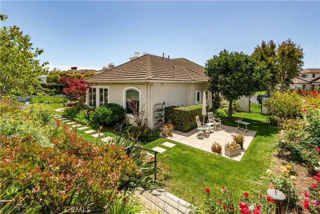 a view of a house with a yard and potted plants