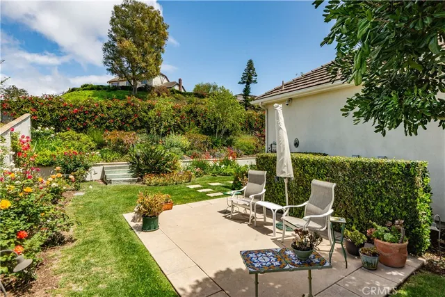 a view of a patio with table and chairs and potted plants