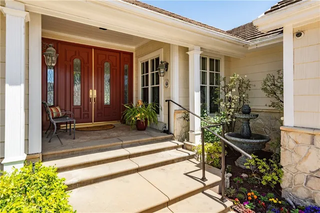 a view of house with patio outdoor seating and plants