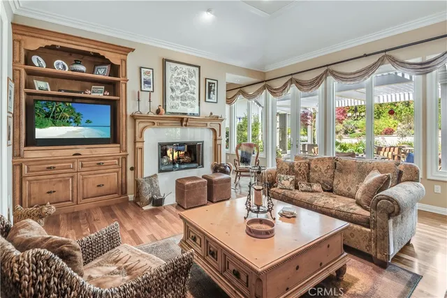 a living room with furniture a flat screen tv and a fireplace