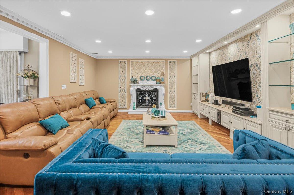626 Caledonia Road Dix Hills, NY 11746 - Photo 8 of 49 a living room with fireplace furniture and a flat screen tv