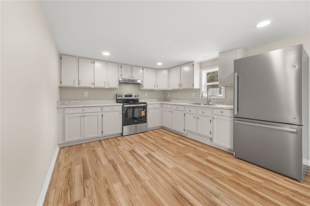 139 Davis Road Easley, SC 29640 - Photo 11 of 34 This modern kitchen features warm wood flooring and ample counter space for all your culinary needs.