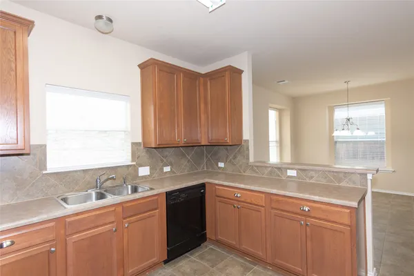 a kitchen with a sink cabinets and window