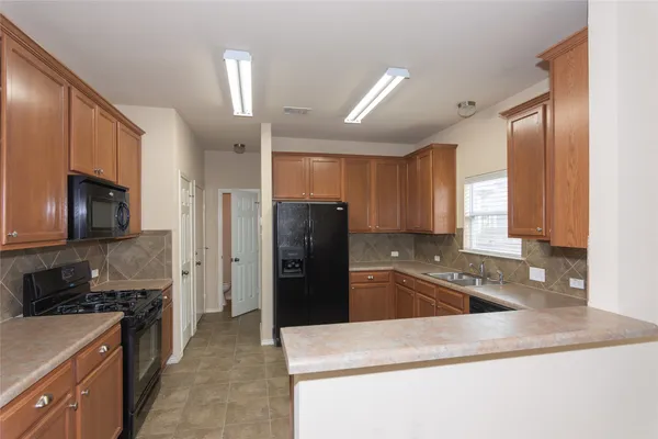 a kitchen with a refrigerator sink and stove