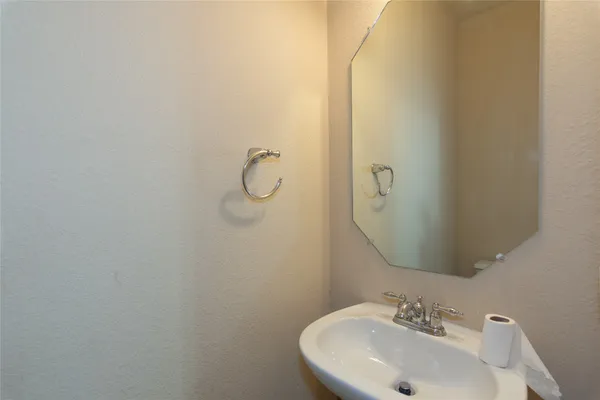 a bathroom with a sink and mirror
