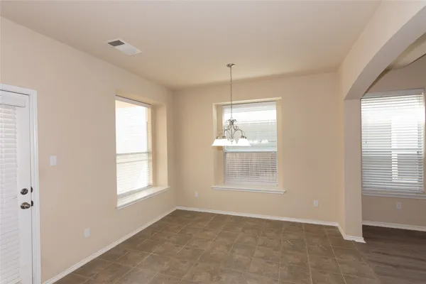 an empty room with windows and closet