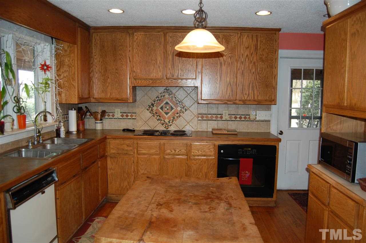 6740 Good Life Road Wendell, NC 27591 - Photo 11 of 25 a kitchen with sink cabinets and a fireplace