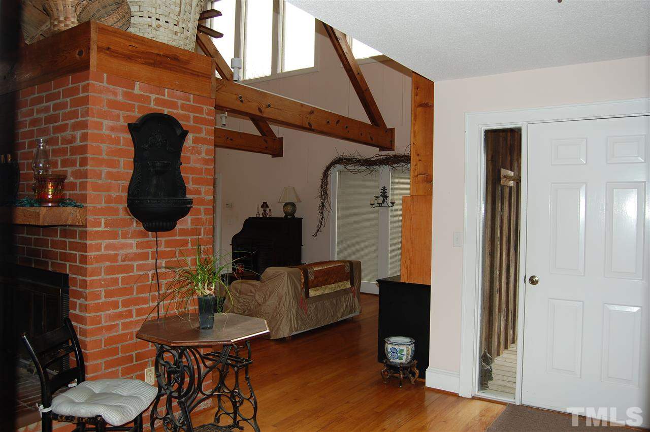 6740 Good Life Road Wendell, NC 27591 - Photo 6 of 25 a living room with furniture and a fireplace