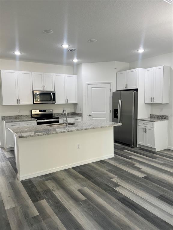 6173 North Matheson Drive Citrus Springs, FL 34434 - Photo 10 of 18 a kitchen with stainless steel appliances granite countertop a refrigerator a stove a sink and white cabinets