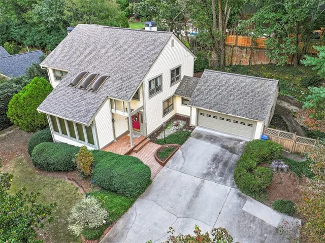 an aerial view of multiple houses with a yard