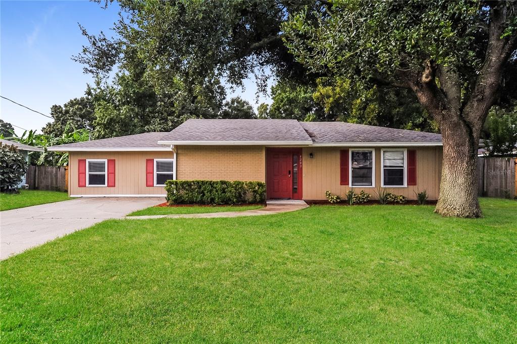4203 Sunny Land Drive Lakeland, FL 33813 - Photo 1 of 1 a front view of a house with a garden