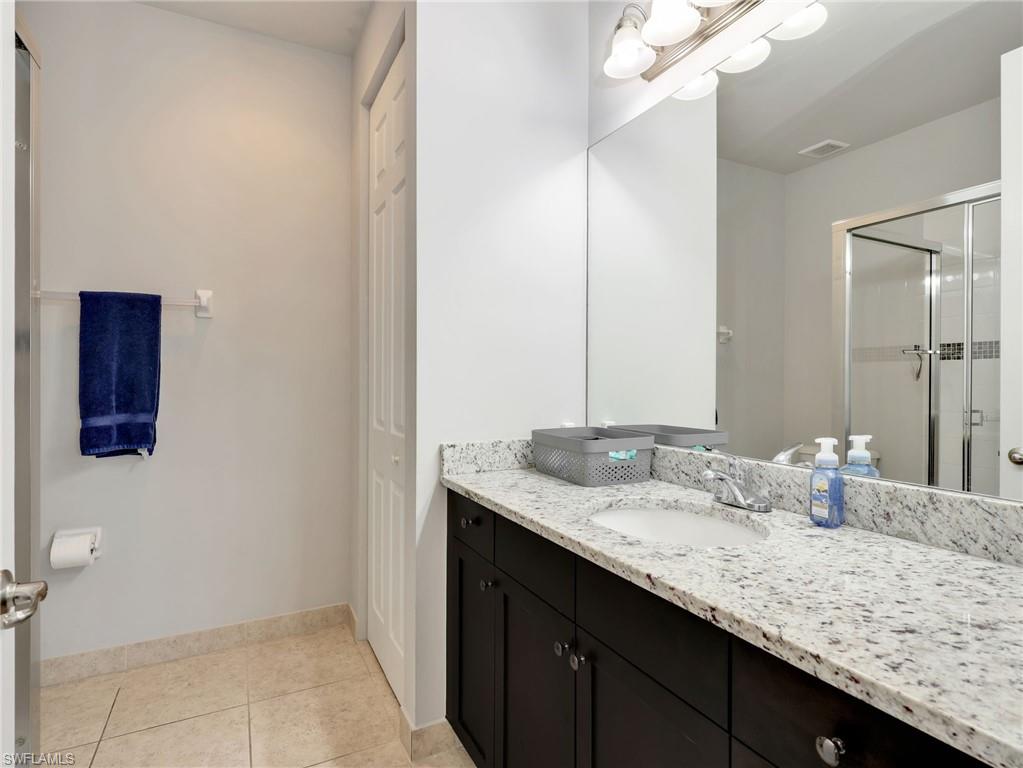 2756 Crystal Way Naples, FL 34119 - Photo 37 of 50 a bathroom with a granite countertop sink and a mirror
