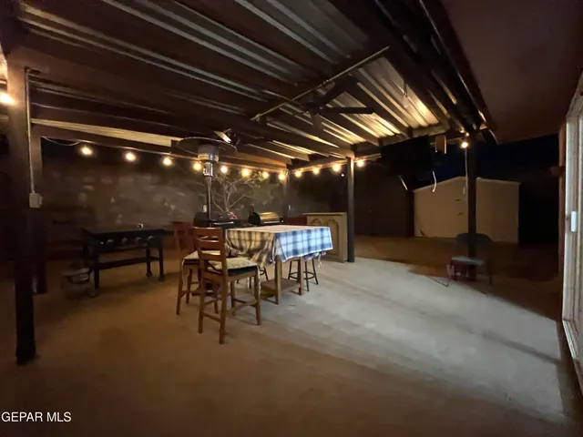 a dining room with furniture and a chandelier