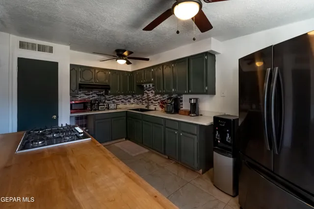 a kitchen with stainless steel appliances a sink stove and refrigerator