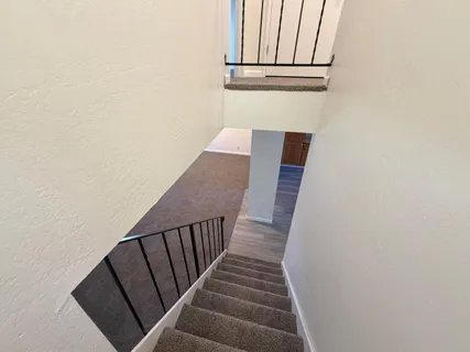 a view of staircase with wooden floor