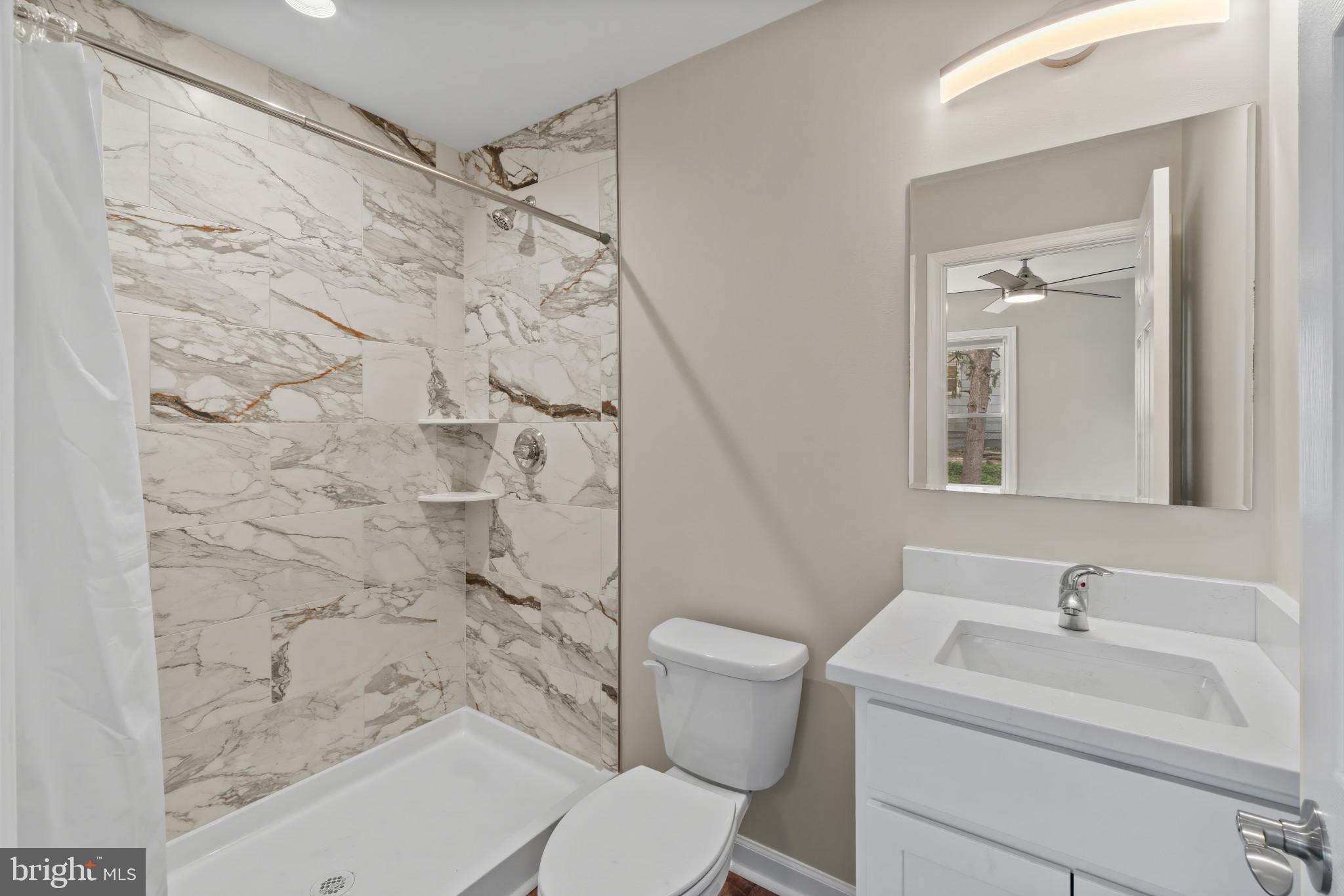 14 Montrose Road Pasadena, MD 21122 - Photo 15 of 19 a bathroom with a sink toilet and shower