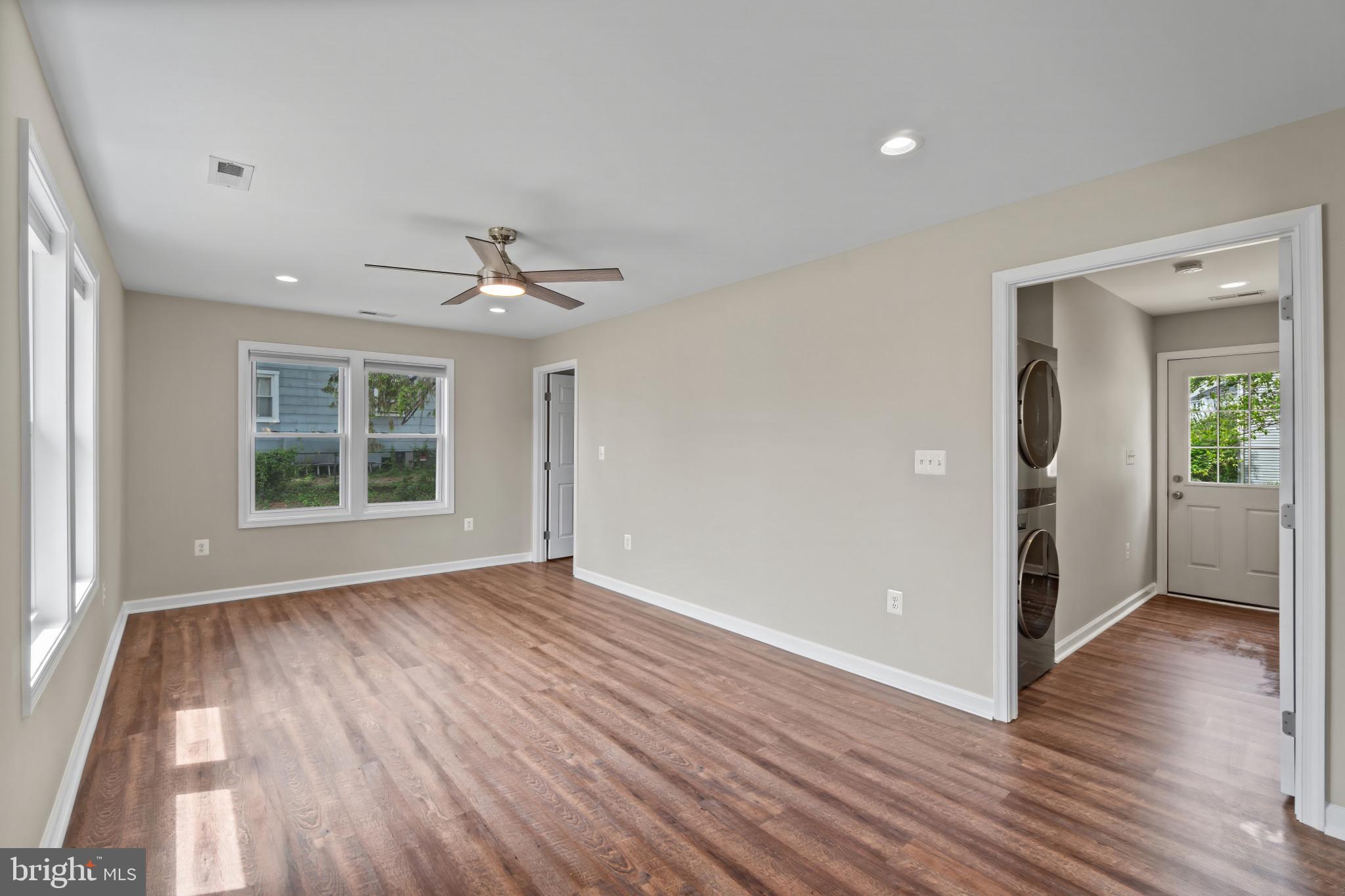 14 Montrose Road Pasadena, MD 21122 - Photo 5 of 19 a view of an empty room with wooden floor and a window