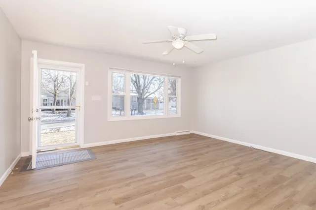 a view of an empty room with wooden floor