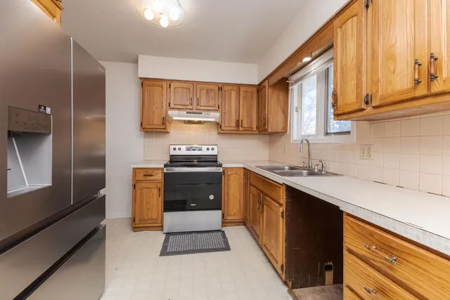 a kitchen with a sink cabinets and a window