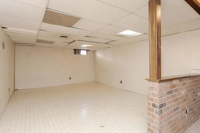 a view of an empty room with a kitchen