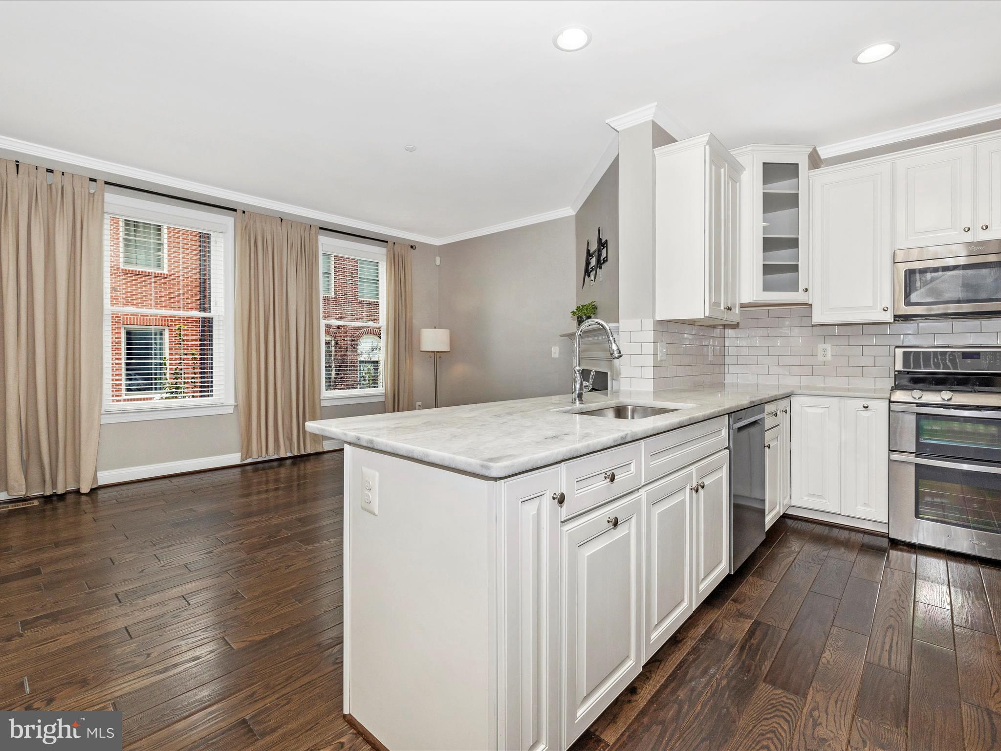 2 Maxwell Square Frederick, MD 21701 - Photo 58 of 59 a kitchen with stainless steel appliances granite countertop a sink stove and cabinets